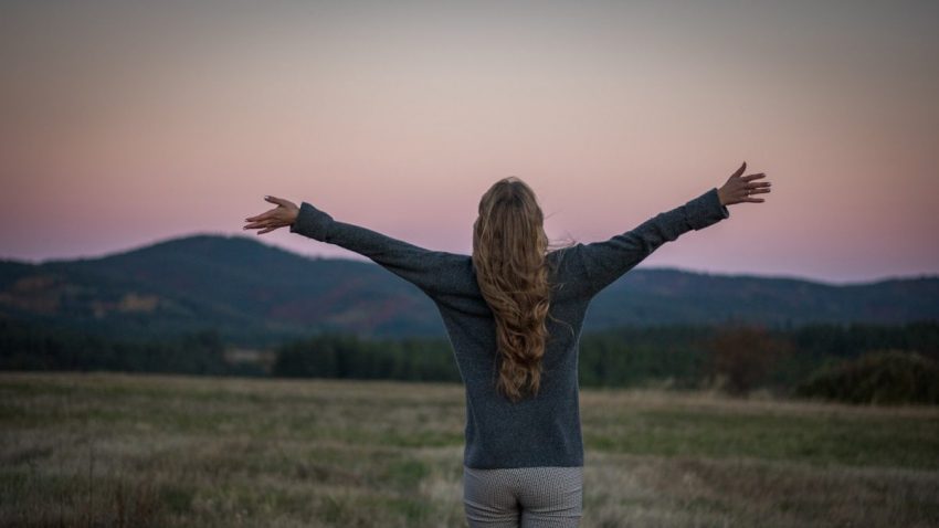 A portrait of a girl from behind just after sunset
